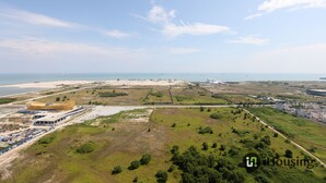 An aerial view of a coastal area with a large building complex, green spaces, and a beach in the background. - Bali Deluxe Melaka By I Housing  (Malacca City)