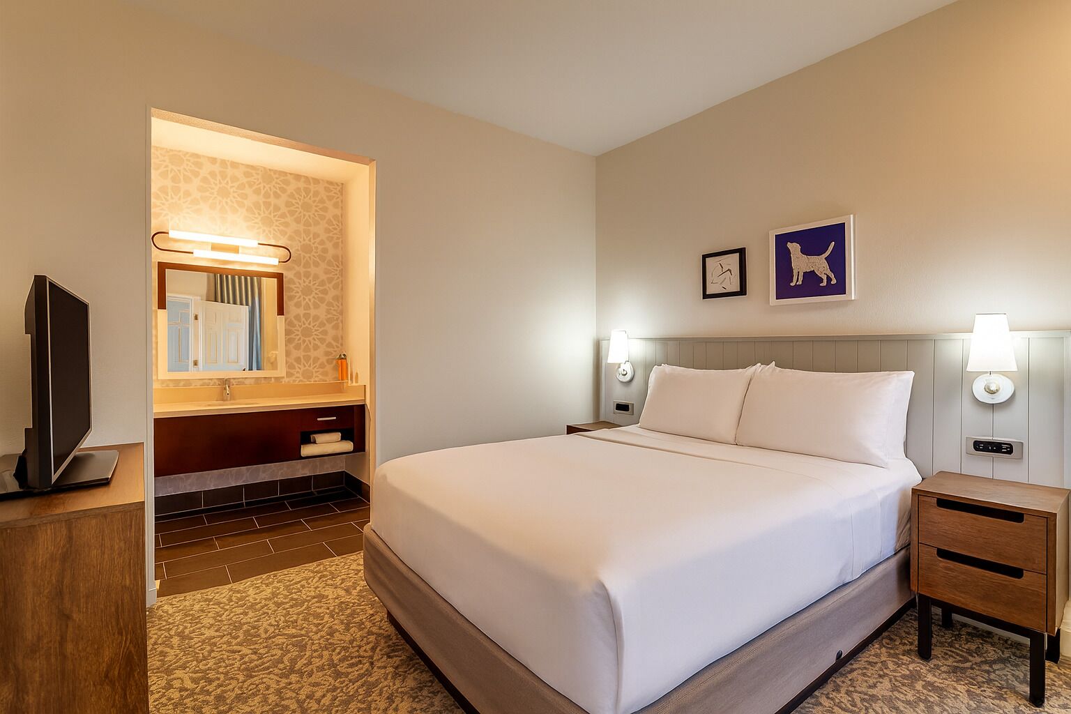 Recharge in the cozy bedroom with extra getting-ready space.