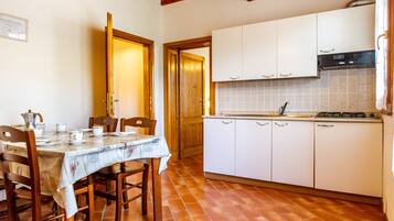 Fridge, stovetop, highchair, cookware/dishes/utensils