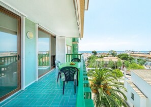 A balcony with a table and chairs, a view of the sea, and buildings in the background. - 'Mirador Altafulla' 5th Floor with Two Terraces and Elevator (altafulla)