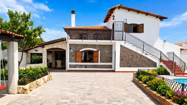 A two-story house with a stone facade, a balcony, and a staircase leading to the upper floor. - Villa 'Casa Al Mare' with Private Terrace, Wi-Fi and Air Conditioning (Siracusa)