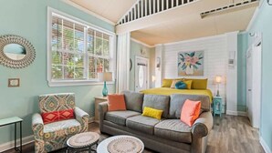 A cozy living room with a sofa, armchair, and round coffee table.
