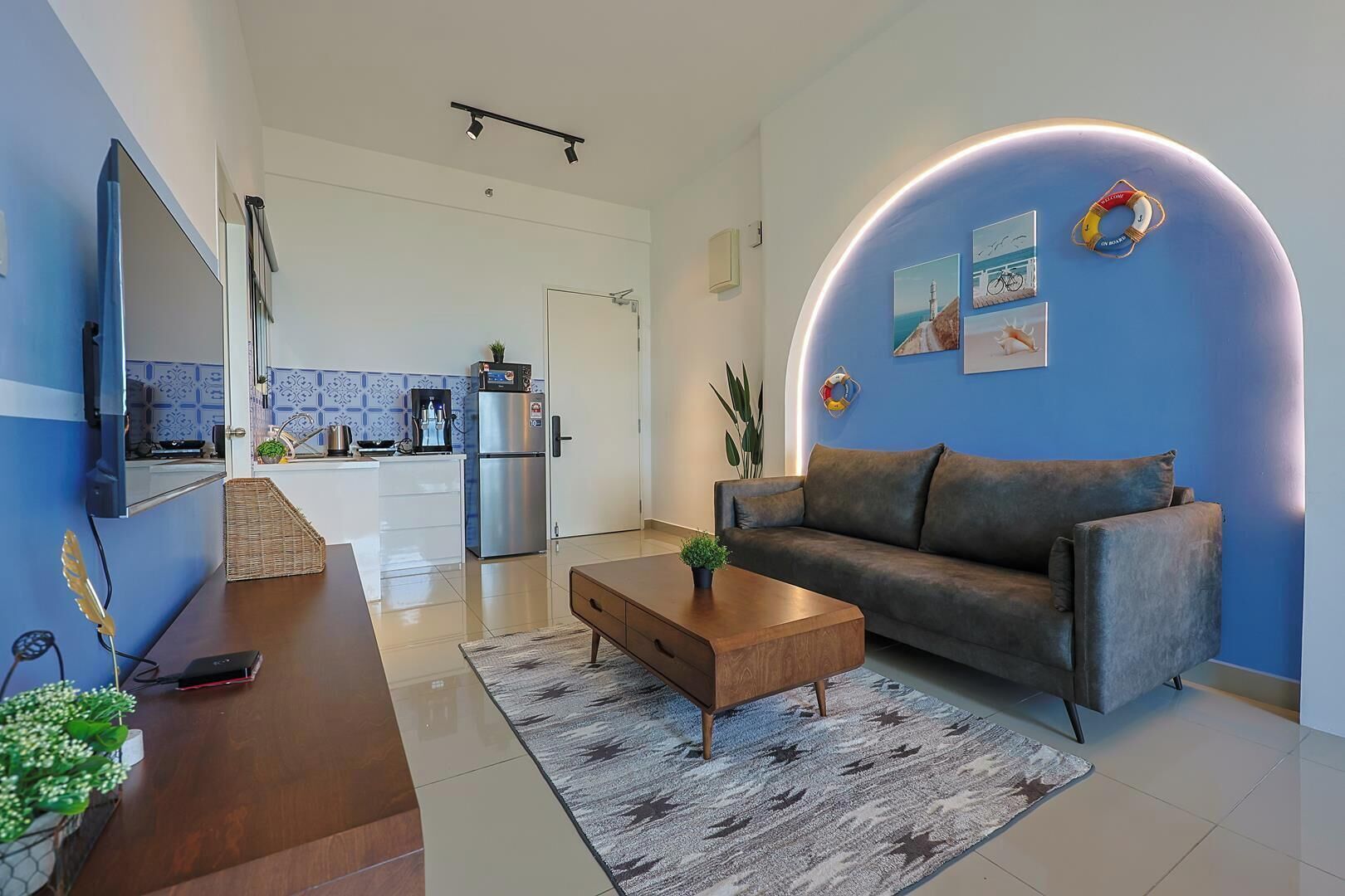 A modern living room with a sofa, coffee table, and a TV.