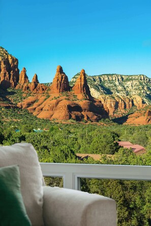 A room with a view of red rock formations and greenery. - Luxury Paradise, 360 Views, Pool/Hot Tub/Firepit! (Sedona)