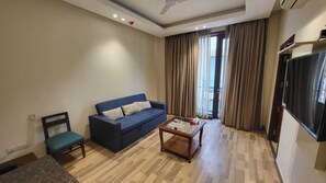 Suite superior, 1 dormitori (Deluxe King) | Sala d'estar | Televisor LED de 32 polzades amb canals per satèl·lit i televisor 