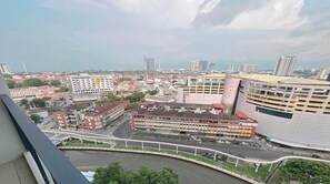 A cityscape with a river, buildings, and a bridge. - The Shore Residence Melaka By I Housing (Malacca City)