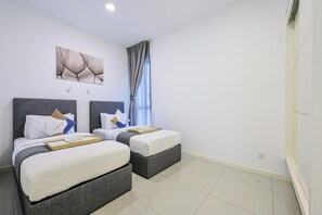 A hotel room with two beds, a large window with curtains, a wall-mounted artwork, and a clean, tiled floor. - The Shore Residence Melaka By I Housing (Malacca City)
