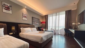 A hotel room with two beds, a desk, a chair, a TV, and a large window with curtains. - The Shore Residence Melaka By I Housing (Malacca City)