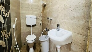 Une petite salle de bain comprenant des toilettes, un bidet et un lavabo.