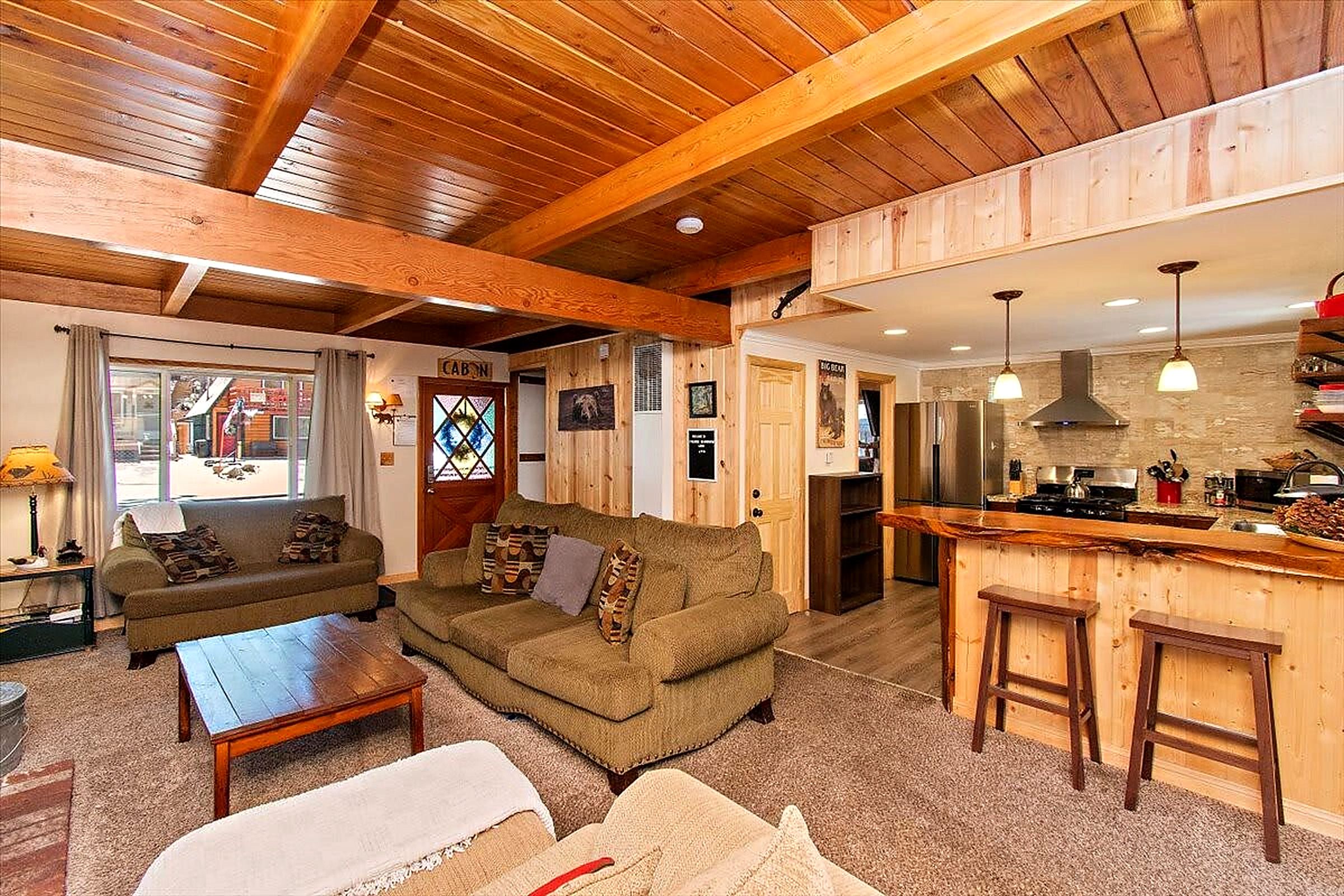 A cozy living room with a sofa, a coffee table, and a fireplace.