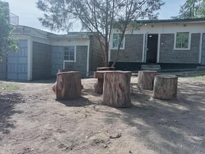 A building with a stone facade, a garage, and a tree in front. - Naivasha Homestay (Naivasha)