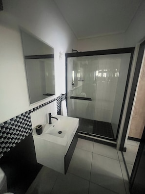 Shower, towels, soap, toilet paper