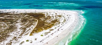 2nd-floor duplex near beach with heated pool, grill, balcony, & W/D