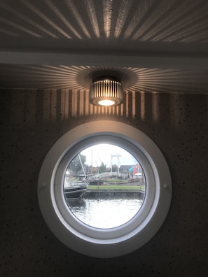 Interior - Modern houseboat in quiet harbor close to the IJsselmeer with SUPs and canoe (Stavoren)