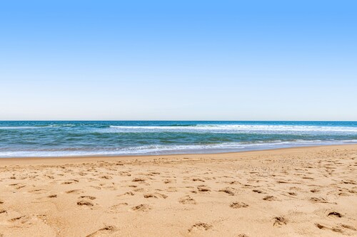 Sea Colony oceanfront condo with private balcony, shared pools, & gym