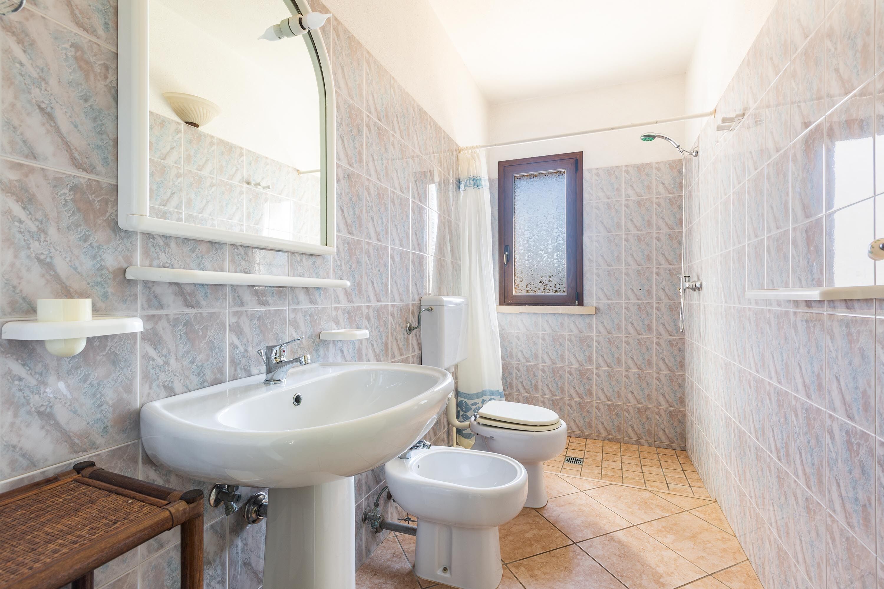 A bathroom with a sink, toilet, and shower.
