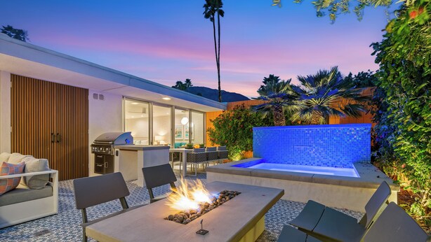 A modern outdoor patio with a fire feature, seating, and a water fountain. - The Desert Breeze at Sandpiper; Completely remodeled with private spa! (Palm Desert)
