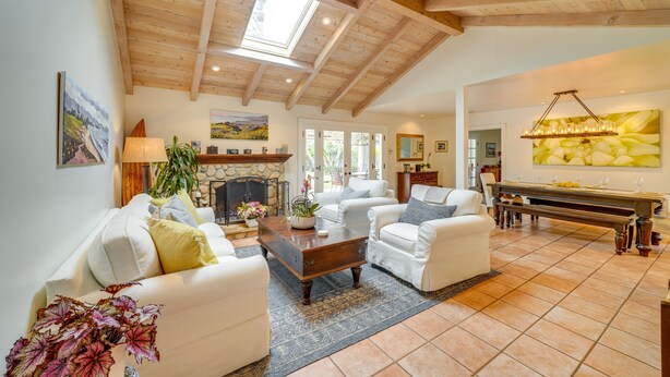 A spacious living room with a fireplace, white sofas, a coffee table, and a piano. - Santa Barbara Vacation Rental w/ Pool & Hot Tub! (Santa Barbara)