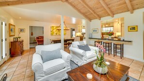 A spacious living room with two white sofas, a wooden coffee table, and a dining area in the background. - Santa Barbara Vacation Rental w/ Pool & Hot Tub! (Santa Barbara)