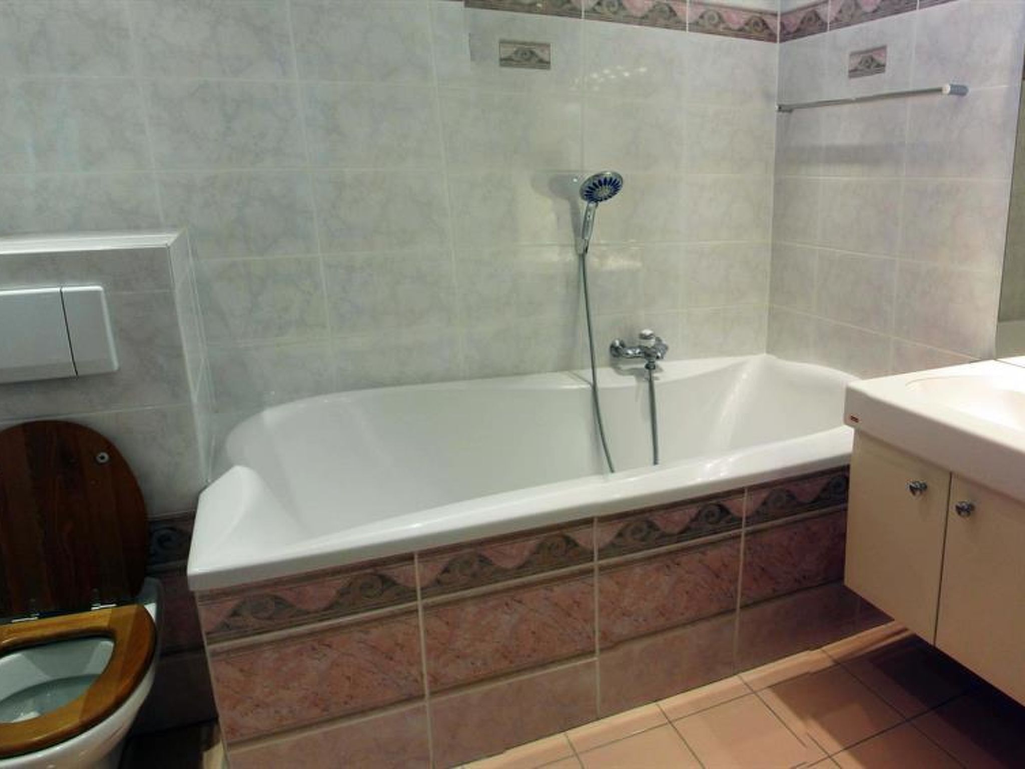 A bathroom with a bathtub, a toilet, and a sink.