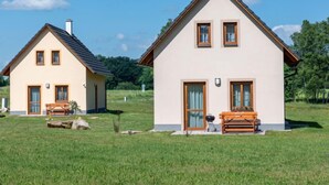 Two houses with a grassy field in the foreground and trees in the background. - Vacation home Bára 1 by Interhome (Straz nad Nezarkou)