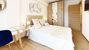 A modern bedroom with a large bed, bedside tables with lamps, a desk, and a wardrobe. - The Paradise: Luxurious flat, parking, jacuzzi, terrace, new (Donostia)