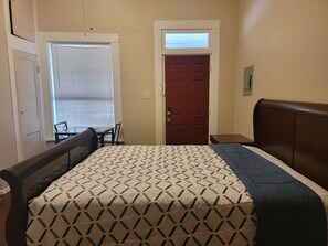 Cozy retreat with a single bed, bedside table, and comfortable chair.