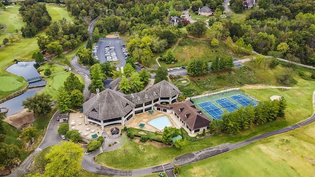 A golf course with a clubhouse, swimming pool, and tennis courts. - Combined Condo & Suite with Lock-off Access at StoneBridge (Reeds Spring)