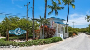 A small building with a blue roof and a sign that reads "Ocean Pointe".