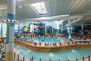 An indoor water park with multiple slides and pools. - Cozy&Tranquil Heaven With KingSuite&Covered Patio&BigFencedYard, 5-Star-Location (Austin)