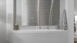 Paredes com um texto emoldurado sobre crenças e a palavra 'HOME' abaixo.