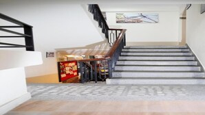 A staircase with a handrail and a wall-mounted picture. - MeroStay204Satkar hotel (Kathmandu)