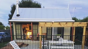 A covered outdoor area with a pool, lounge chairs, and a wooden deck. - Prvt cottage + cabin + pool on quarter acre section (wood burner, pet friendly) (Greytown)