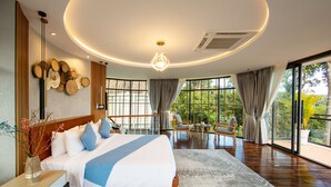 A modern bedroom with a large bed, a desk, and a view of the outdoors. - Bird Nest Villas by Mafiya (Koh Rong)