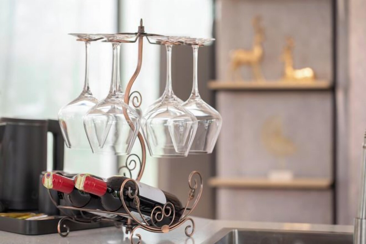 A wine rack with three glasses and a bottle of wine.