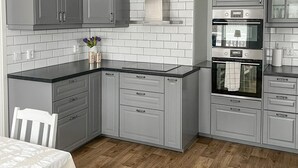 A kitchen with grey cabinets, a black countertop, and a wooden floor. - Stunning home in Tingsryd with WiFi (Tingsryd)