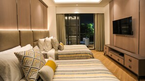 A modern bedroom with two beds, a TV, and a balcony with curtains. - Atithi House (Greater Noida)