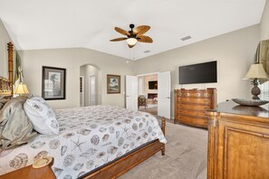 A bedroom with a bed, dresser, television, and ceiling fan. - Willie’s Place w/Golf Cart, Hot Tub & Dog Friendly (The Villages)