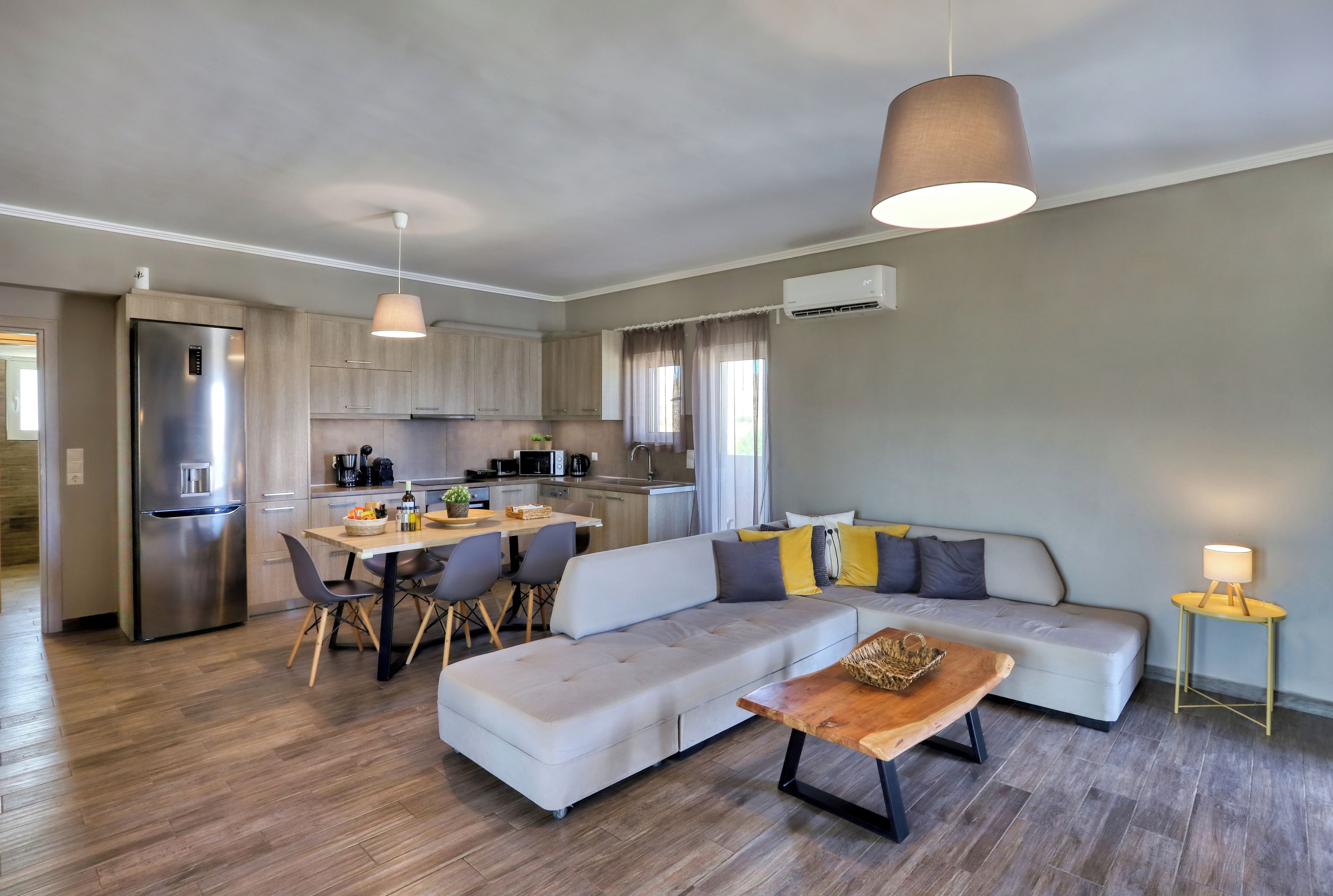 A modern living space with a kitchen, dining area, and seating area.