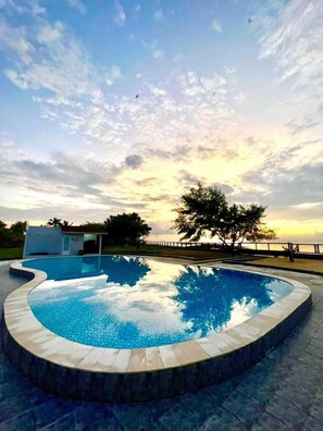 2 outdoor pools, open 7:00 AM to 10:00 PM, pool umbrellas