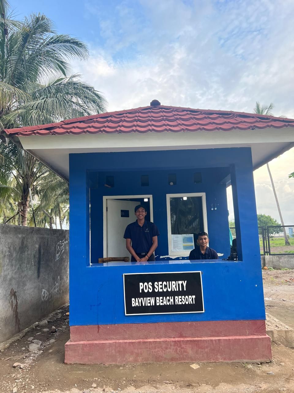 A blue security booth at Bayview Beach Resort with two individuals inside.