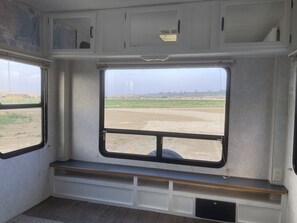 Enjoy the serene view from the window seat in this cozy space.