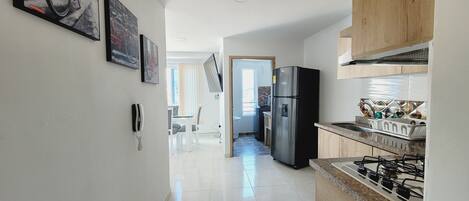 Fridge, microwave, coffee/tea maker, cookware/dishes/utensils