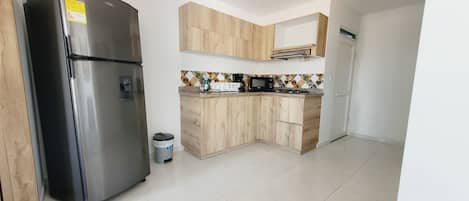 Fridge, microwave, coffee/tea maker, cookware/dishes/utensils