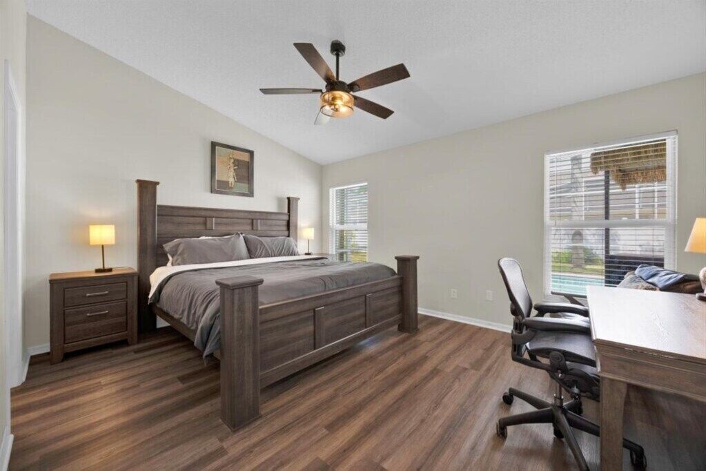 Spacious primary suite featuring a plush king-size bed.