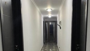 A hallway with marble flooring, black doors, and recessed lighting. - Hotel Charli (Kobuleti)