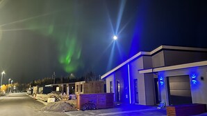 A modern building with a paved entrance and a bicycle parked outside. - Spacious villa in Golden Circle with amazing view & hot tub! (Reykholt)