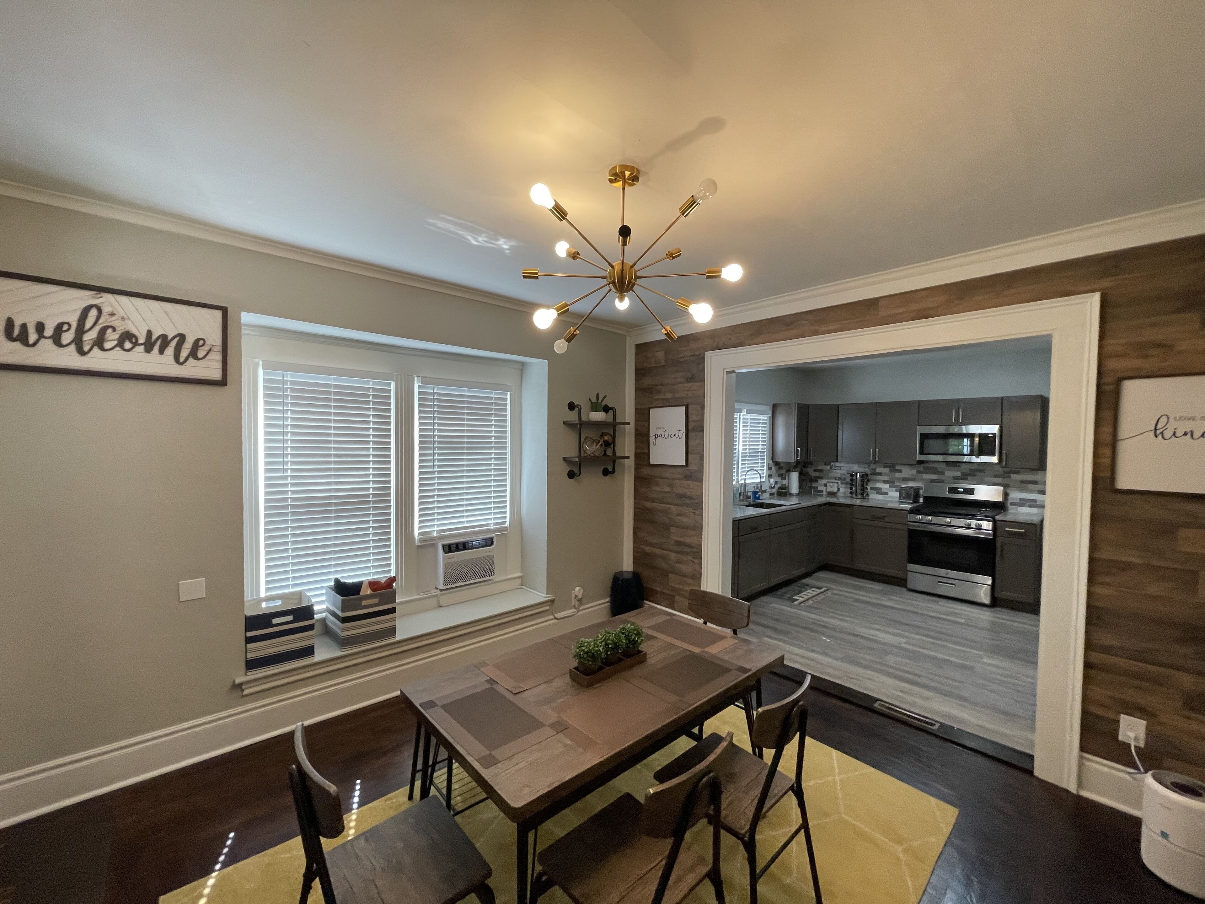A modern kitchen with dark wood cabinetry, stainless steel appliances, and a central island.