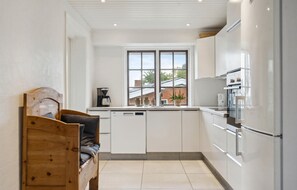 Fridge, stovetop, dishwasher, coffee/tea maker