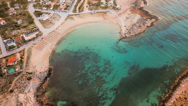 An aerial view of a coastal town with a beach, houses, and a road. - Lydia Apartment (Chania)